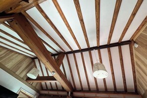 A room with exposed wooden beams and a sloped ceiling. - Traditional House Hotel Andong Villa (Andong-si)