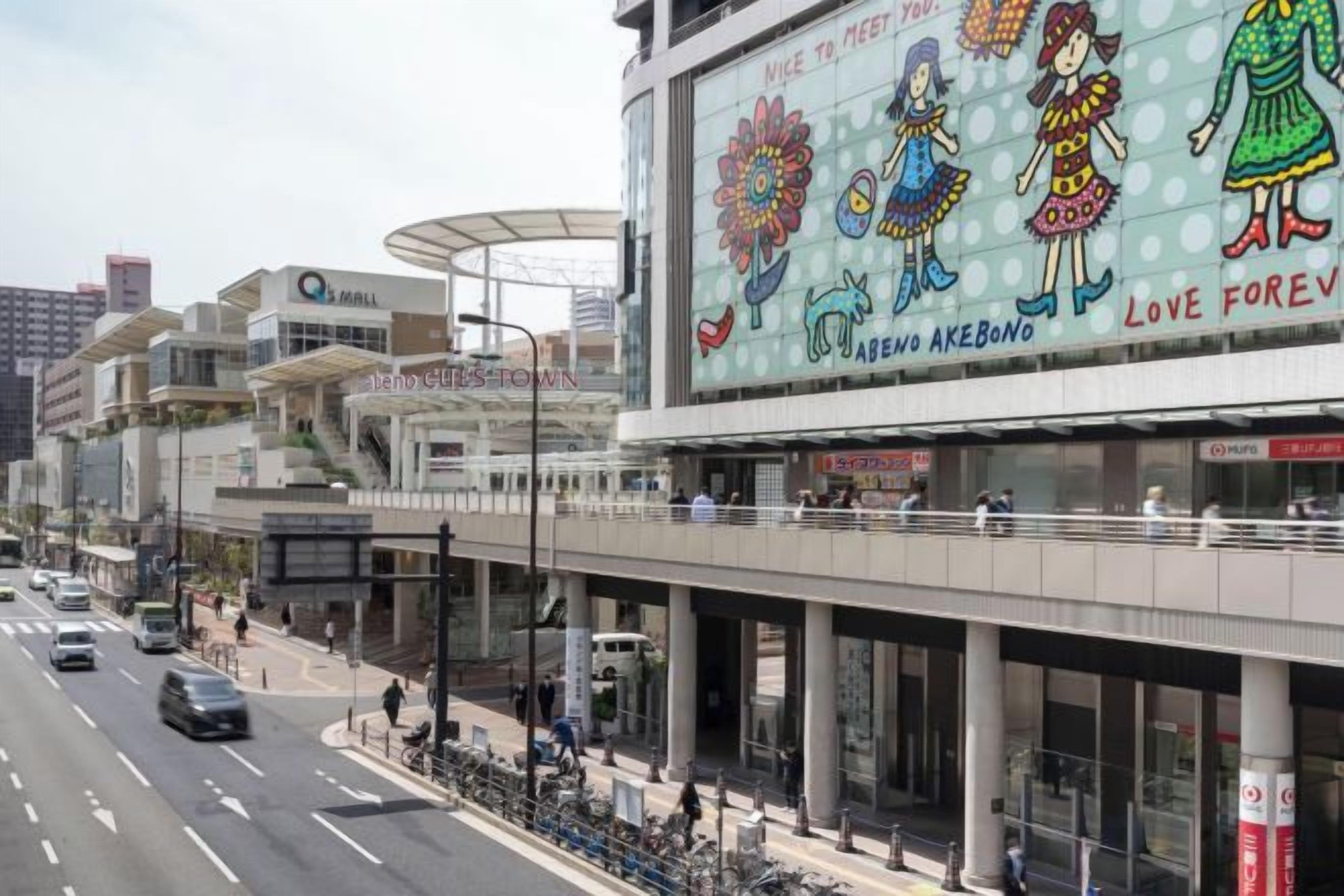 Un centre commercial à plusieurs niveaux, avec un grand panneau publicitaire faisant la promotion d’une marque.