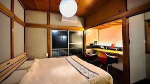 A room with a bed, a desk, and a chair.