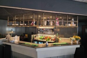 A bar area with a counter, shelves, and various bar items. - City Hotel Winschoten (Winschoten)