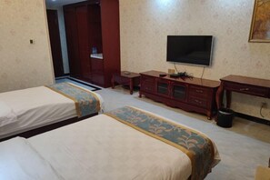 A hotel room with two beds, a TV, a desk, and a wardrobe. - Chinese Chamber of Commerce Hotel (Nouakchott)