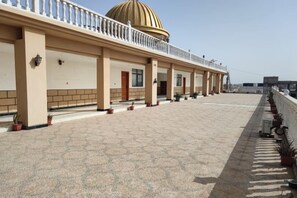 A covered outdoor area with a patterned floor, a series of columns, and a dome structure. - Chinese Chamber of Commerce Hotel (Nouakchott)