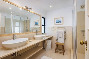 Shower, hair dryer, towels, toilet paper