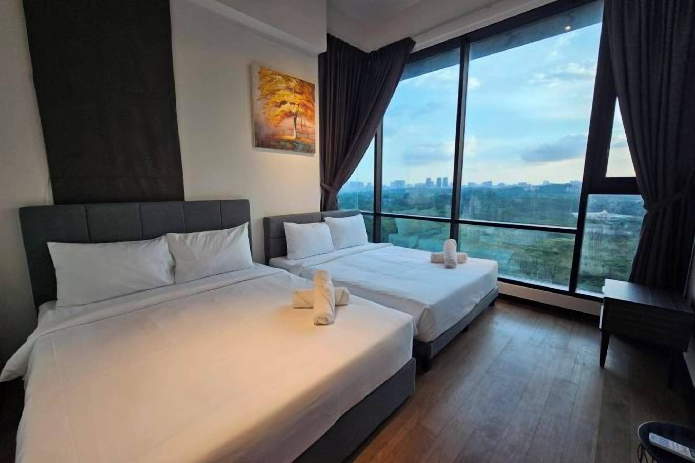 A hotel room with two beds, a large window, and a painting on the wall.