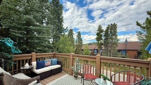A deck with outdoor furniture, including a sofa, chairs, and a table. - The Retreat #6 (Breckenridge)