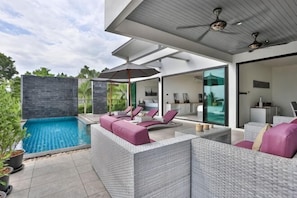 A modern outdoor living area with a pool, wicker furniture, and a ceiling fan. - Villa Hayou, Lamai Koh Samui (Koh Samui)