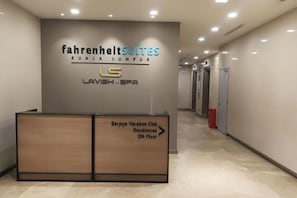 A hotel reception desk with a sign for Fahrenheit Suites Kuala Lumpur and Lavish Spa. - Fahrenheit 88 Suites Bukit Bintang by Roseline (Kuala Lumpur)