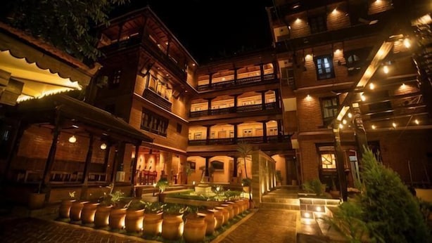 A multi-story building with a courtyard, balconies, and outdoor lighting. - Nagpukhu Guest House (Bhaktapur)