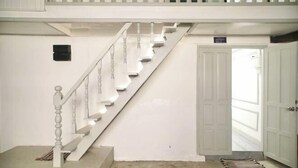A staircase with white balusters leading to a landing.