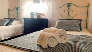 A hotel room with two beds, a nightstand, a dresser, and a window with sheer curtains. - Agroturismo Quinta Vale Salgueiro - Aurora family house - Serra da Estrela (Carragozela)