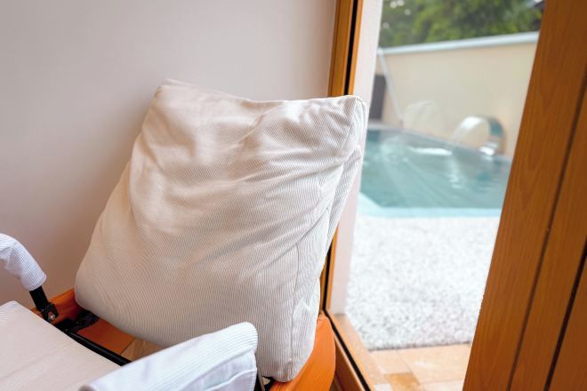 A room with a view of an outdoor swimming pool.