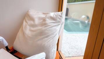 A room with a view of an outdoor swimming pool.