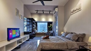 A modern bedroom with a bed, a TV, a desk, and a staircase leading to an outdoor area. - Thermospace Imperio A-27-07 Melaka City (Melaka)