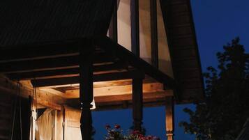 A wooden structure with a pitched roof and a visible window.