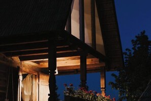 A wooden structure with a pitched roof and a visible window. - ECHOES OF VLĂDICU (Cluj-Napoca)