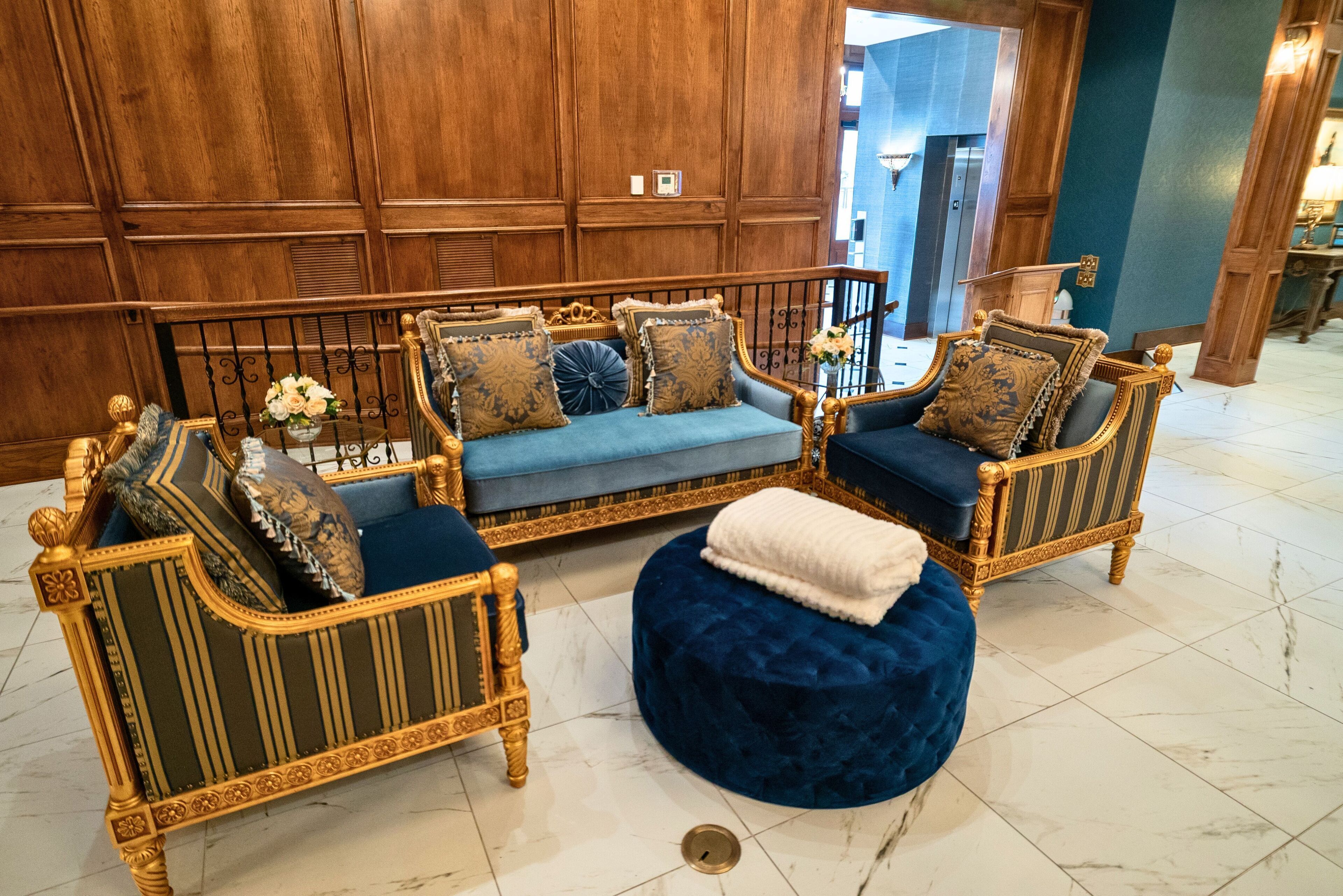 A luxurious seating area with ornate furniture and a marble floor.