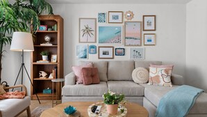 A living room with a sofa, coffee table, and bookshelf.