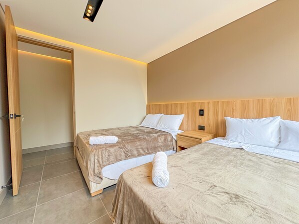 Deluxe Apartment, Garden View | Desk, laptop workspace, blackout curtains, soundproofing