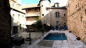 A courtyard with a swimming pool, stone buildings, and outdoor seating. - Holiday Home 'L'ancien Collège' with Private Pool, Wi-Fi and Air Conditioning (Hérisson)