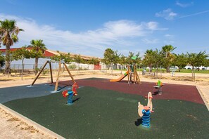 A playground with swings, slides, and climbing structures.