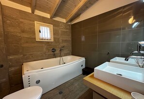 A modern bathroom with a freestanding bathtub, a double sink vanity, and a toilet. - The Dream Villa Kastoria (Kastoria)
