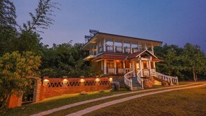 A two-story house with a balcony, a staircase, and a well-maintained garden. - Johns Village  (Mulanthuruthy)