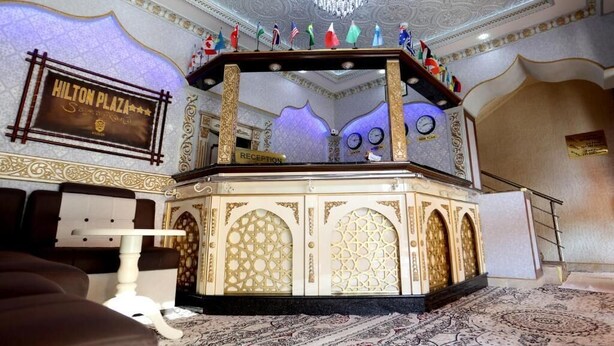 A reception area with a sign reading "Hilton Plaza." - HOTEL PLAZA 777 (Samarkand)