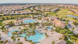 A resort with multiple swimming pools, palm trees, and a golf course. - 6-bedroom Private Pool House Championsgate (Davenport)