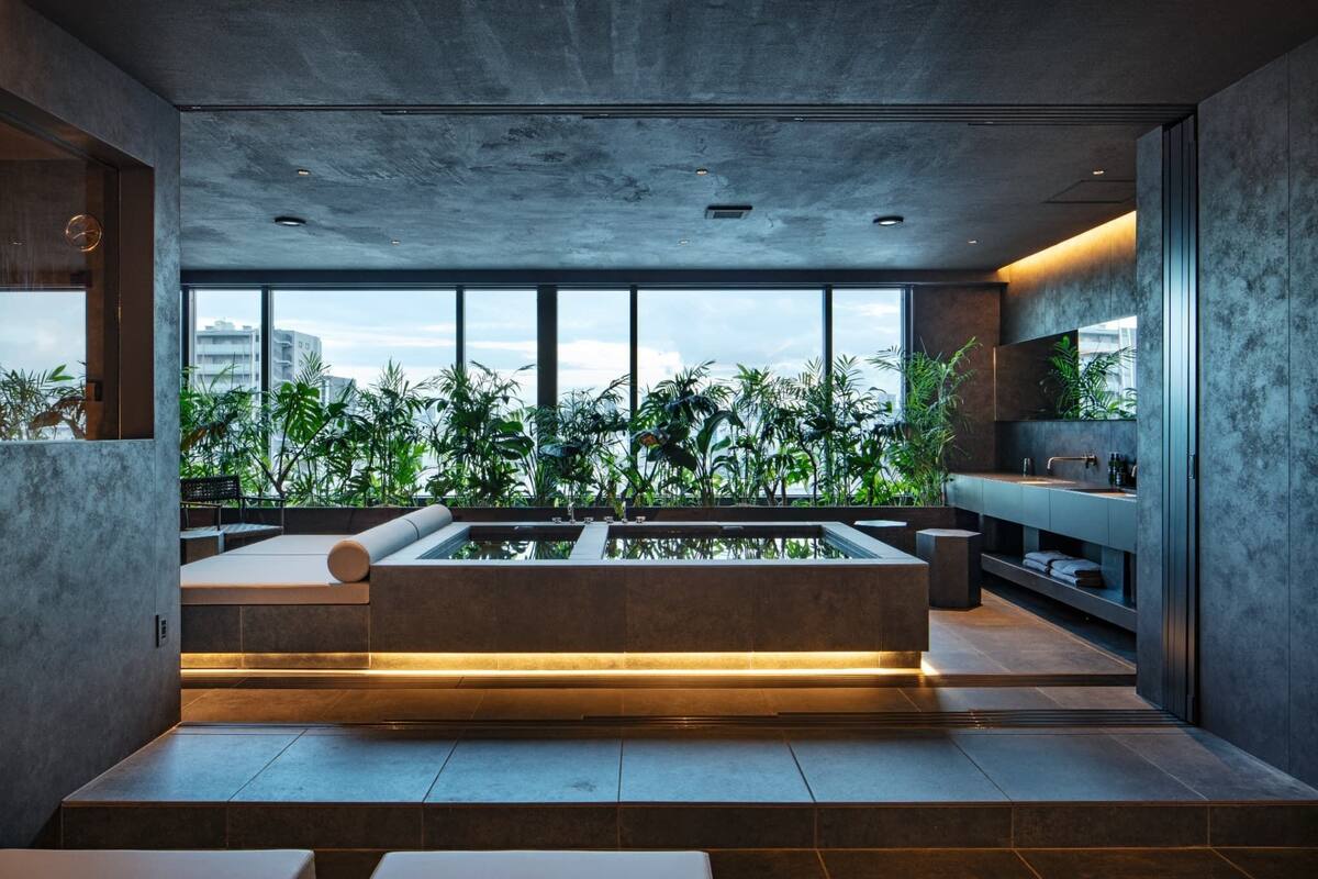 A modern interior with a large window, a built-in bench, and a water feature.