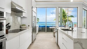 Et moderne køkken med havudsigt, en balkon og et spiseområde.