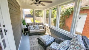 A sunroom with wicker furniture, large windows, and a ceiling fan. - Blueberry Cottage - Downtown Park City (Park City)
