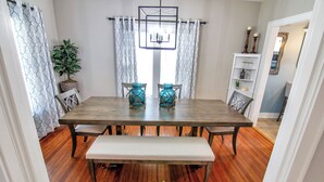 A dining area with a wooden table, two blue vases, a bench, and a potted plant. - Blueberry Cottage - Downtown Park City (Park City)
