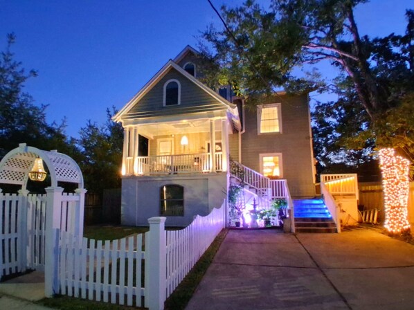 A two-story house with a porch, a small staircase, and a white picket fence. - Uptown Masterpiece, Luxury Central to Everything (New Orleans)