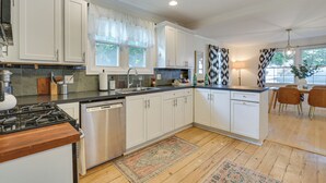 A modern kitchen with white cabinets, a stainless steel dishwasher, and a wooden countertop. - Classic Forest Park Foursquare < 1 Mi to Blue Line (Forest Park)