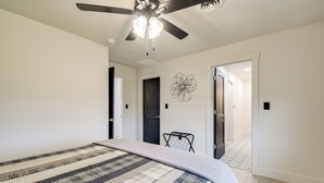 A bedroom with a bed, ceiling fan, and a door leading to another room. - 10 Mi to Red River Gorge: Peaceful Rural Getaway! (Campton)
