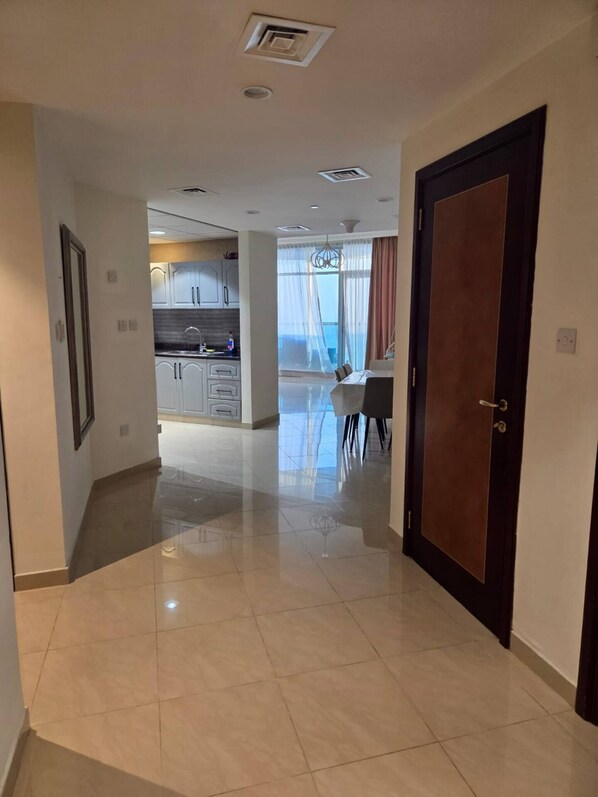 A modern kitchen with white cabinets and a dining area with a table and chairs.