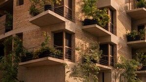 A multi-story building with balconies, some with plants. - Torrearena Design Hotel (Puerto Escondido)