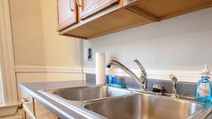 A kitchen with two stainless steel sinks, wooden cabinets, and a countertop. - 5 Min to Salem~Comfy King Beds (Beverly)