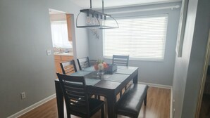 A dining area with a table, chairs, and a hanging light fixture. - Tampa Travel Hub - TPA Airport tranquility (Tampa)