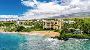 A coastal resort with beachfront properties, a large hotel building, and lush greenery. - Polo Beach Club 801 | 8th Floor Ocean Views, Beachfront Pool & Beach Access (Wailea)