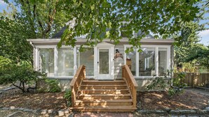 A two-story house with a front porch, a mailbox, and a number sign. - Garden Home Estate, Two Kitchens (Portland)