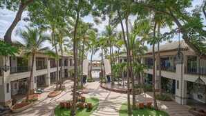 A courtyard with palm trees, outdoor seating, and a central open space. - Wailea Ekahi Village 54D | Sweeping Ocean Views, Updated Kitchen & Resort Pools (Wailea)