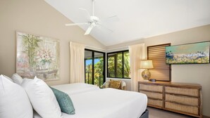 A bedroom with a bed, a ceiling fan, a TV, a window with curtains, and a wall-mounted clock. - Wailea Elua Village 1502 | Ocean View, 2 Min to Ulua Beach, Pools & Pickleball (Wailea)