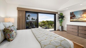Un dormitorio moderno con una cama grande, un balcón con vistas, una planta en maceta y un cuadro en la pared.