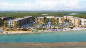 A resort with multiple buildings, a beach, and a water body. - Porto 2 Life - GAV Hotéis e Resorts (Ipojuca)