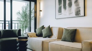 A modern living room with a sofa, armchairs, a coffee table, and a bookshelf. - Luxurious brand new Apt in the heart of miraflores (Lima)