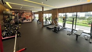 A modern gym with treadmills, elliptical machines, and weightlifting equipment. - Luxurious brand new Apt in the heart of miraflores (Lima)