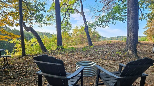 A campsite with two Adirondack chairs and a metal fire pit. - Hocking Hills Store Campsite #3 (Tent Site) (Washington Township)