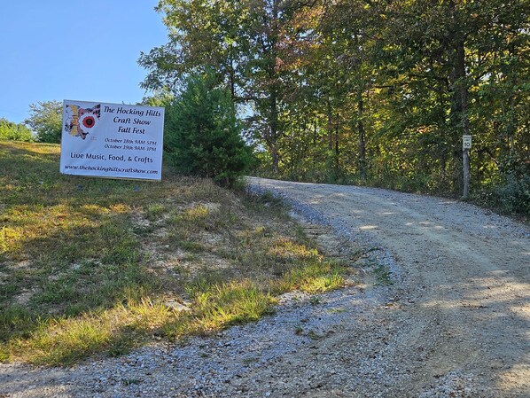 A sign for The Hocking Hills Craft Show Fall Fest with dates and website.