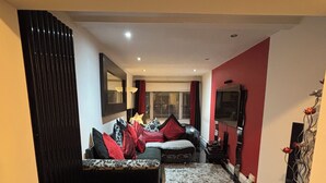Uma sala de estar moderna com um conjunto de sofá, uma mesa de centro e um tapete.